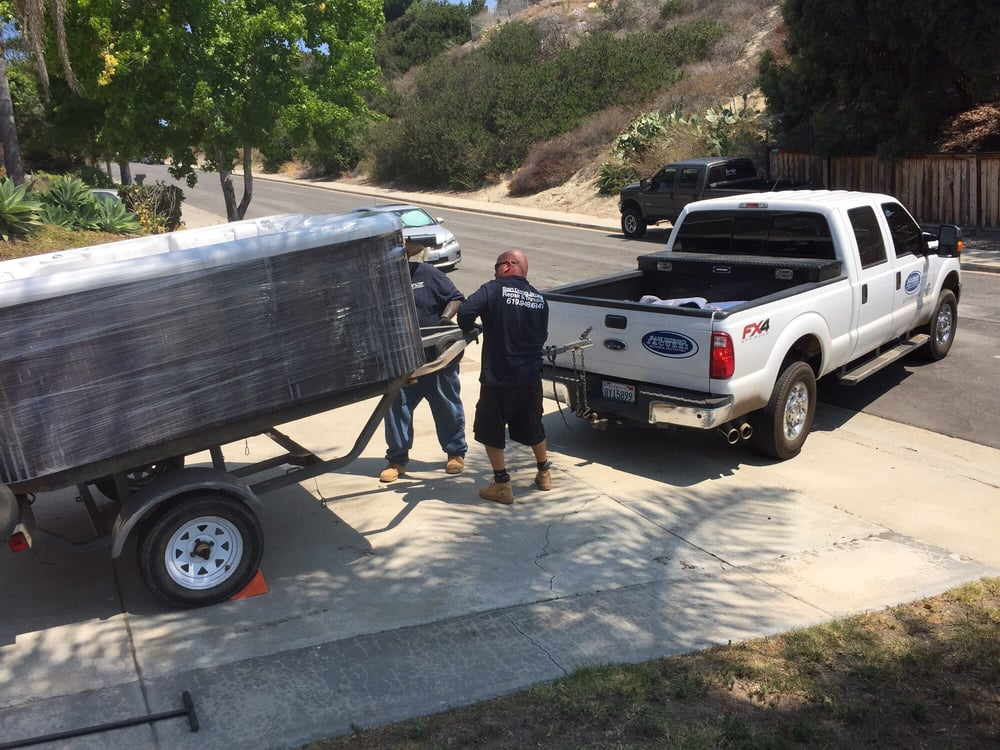 San Diego Jacuzzi Transport crew loading a wrapped spa onto their truck